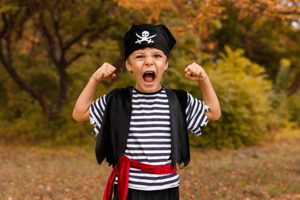 istock Little boy in pirate costume showing strength 1337722188