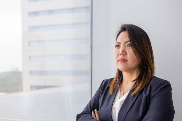 istock japanese woman looking out the office window 1337725649