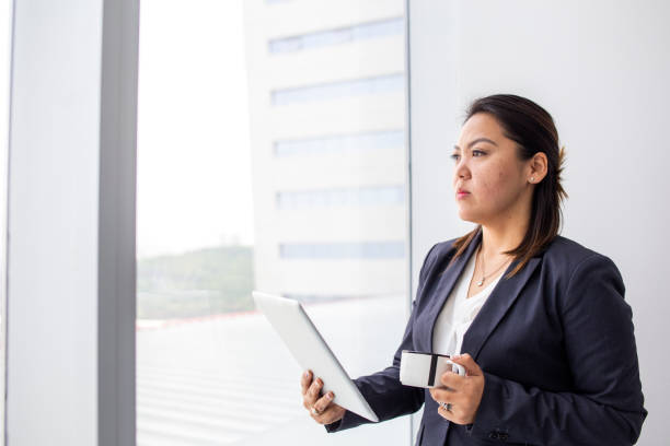istock japanese woman looking out the office window 1337726161