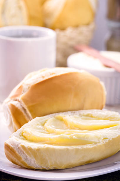 slice of salt bread cut with butter, called French bread in Brazil, Brazilian breakfast bread with butter, Brazilian afternoon coffee, Brazilian confectionery hot breakfast stock pictures, royalty-free photos & images