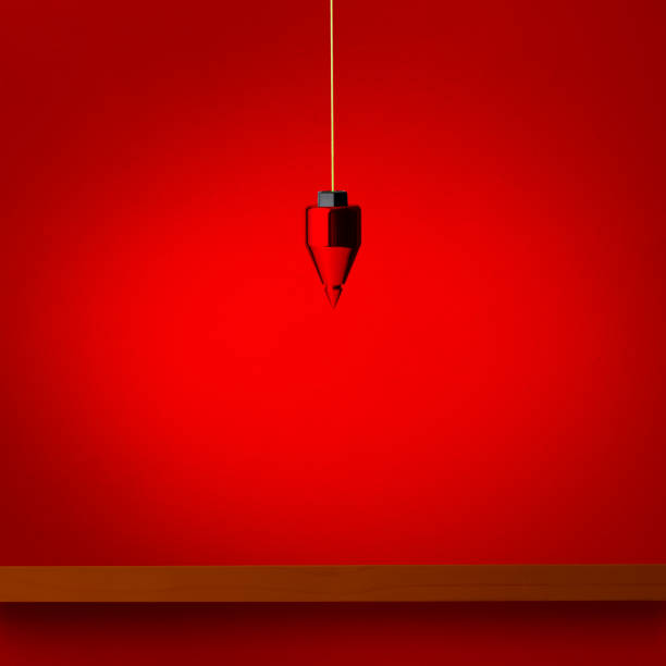 Hanging a plumb bob over the wooden shelf. Hanging a plumb bob over the wooden shelf against red wall. plumb line stock pictures, royalty-free photos & images