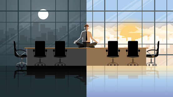 Serious office people in the morning day and night. Peaceful mind businessman sitting cross-legged on a table in a conference room. Meditation and Mindfulness to reduce stress from hard work