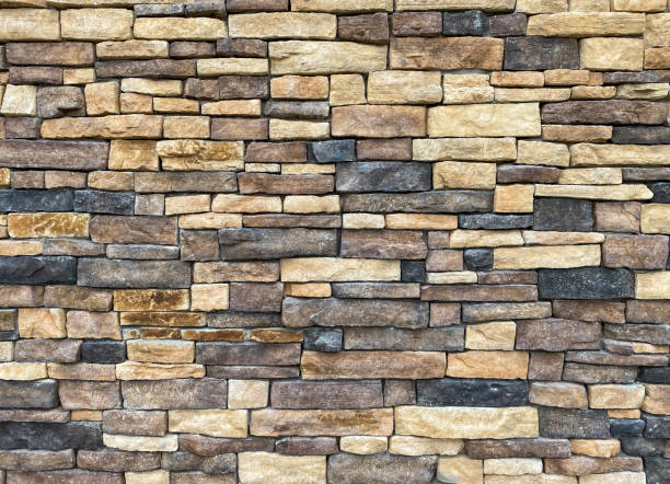 istock distant view of rock stone block structure building wall with black brown and tan blocks 1337735715