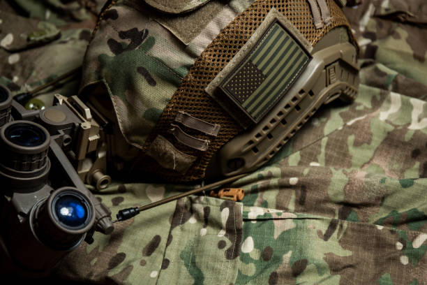 istock Tactical FAST helmet with US flag,  night vision goggles and multicam background 1337739530