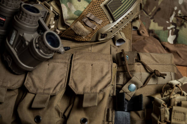 istock Special forces tactical helmet with night vision goggles on a plate carrier vest background 1337739541