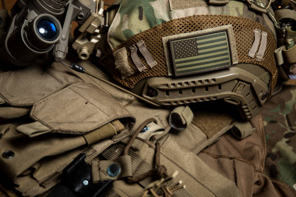 istock Special forces tactical helmet with night vision goggles on a plate carrier vest background 1337739542