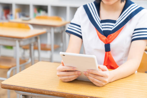 istock schoolgirl studying in the classroom,tablet computer,hands, 1337746688