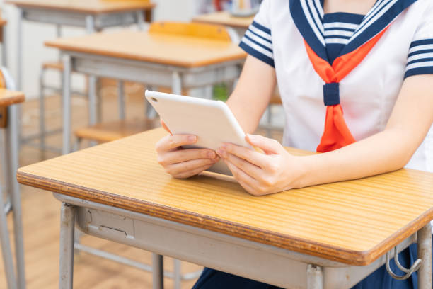istock schoolgirl studying in the classroom,tablet computer,hands, 1337746698