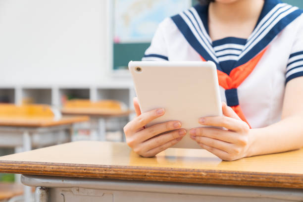 istock schoolgirl studying in the classroom,tablet computer,hands, 1337746704