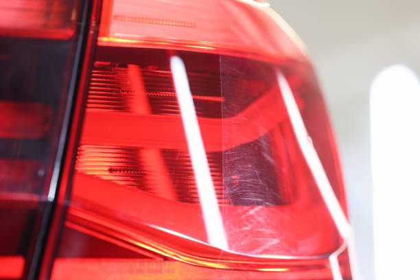 istock Closeup of polished car headlight before and after 1337751300