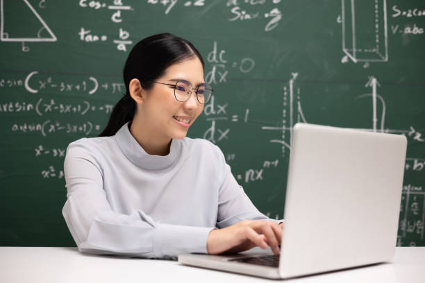 Young asian teacher woman sitting using laptop video conference with student. Female teacher training the mathematics in classroom from live stream with computer online course. Young asian teacher woman sitting using laptop video conference with student. Female teacher training the mathematics in classroom from live stream with computer online course. mba online stock pictures, royalty-free photos & images