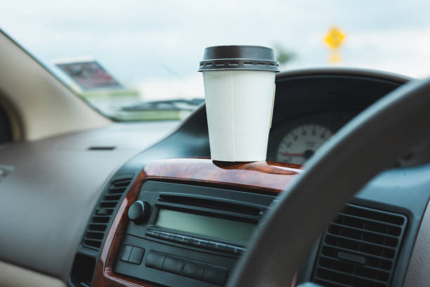 istock A cup of hot coffee put on the car console. Drinking coffee while travel by car. 1337751638