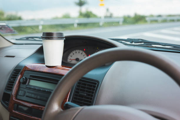 istock A cup of hot coffee put on the car console. Drinking coffee while travel by car. 1337751641