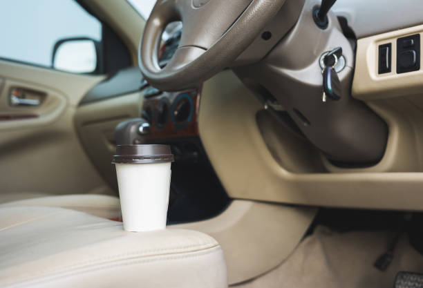 istock A cup of hot coffee put on the car console. Drinking coffee while travel by car. 1337751644