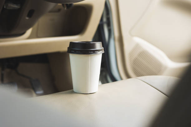 istock A cup of hot coffee put on the car console. Drinking coffee while travel by car. 1337751646