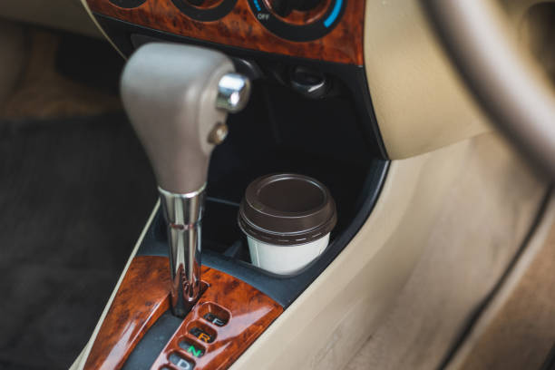 istock A cup of hot coffee put on the car console. Drinking coffee while travel by car. 1337751648