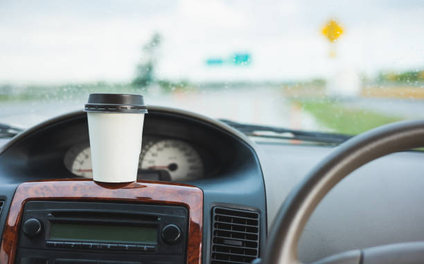 istock A cup of hot coffee put on the car console. Drinking coffee while travel by car. 1337751652