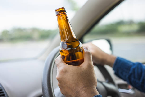 istock Young man drinking beer while driving Risk of accidents due to drunk driving 1337751675