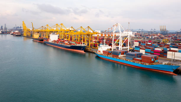 istock Container ship at industrial port in import export global business services logistic and transportation, Container ship loading and unloading freight shipment by cranes , Aerial view 1337752312