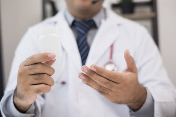 istock Doctor talks to patient via online video conferencing looking at camera wearing headset. Explain about taking medications to treat illnesses. 1337752555