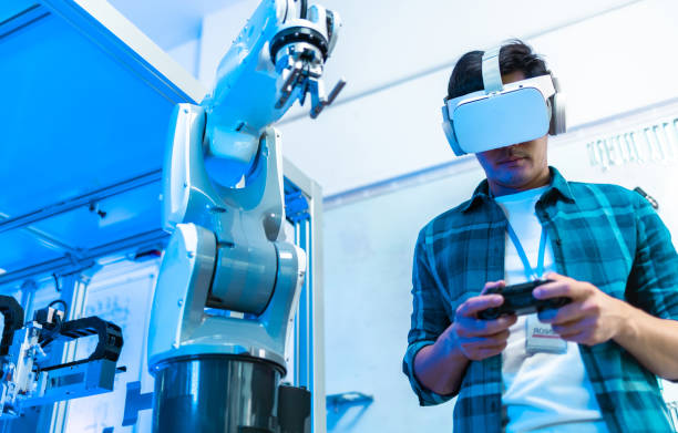 istock Male Engineers Maintenance Robot Arm at Lab. he are in a High Tech Research Laboratory with Modern Equipment. Professional Japanese Development Engineer is Testing an Artificial Intelligence.start up 1337753465
