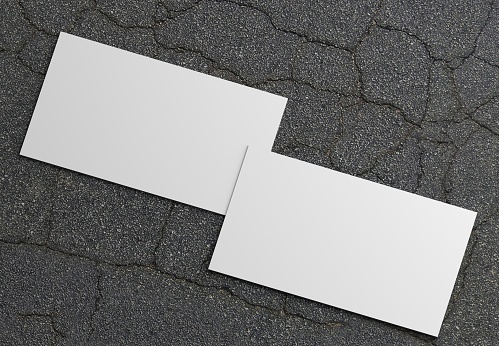 Photo of white business cards isolated on gray background. Template for branding identity. For graphic designers presentations and portfolios. Business Card isolated on gray. White business card mock-up. Photo mock up.