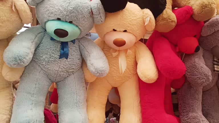 Lots of big multicolored teddy bears in the store