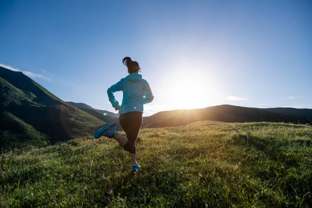 istock Young woman runner running at mountain top 1337758759