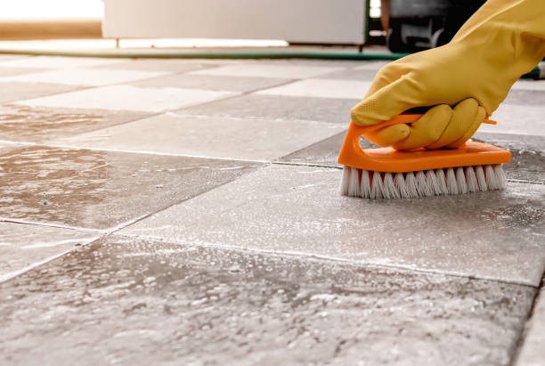 istock Using a plastic floor scrubber to scrub the tile floor with a floor cleaner. 1337761801