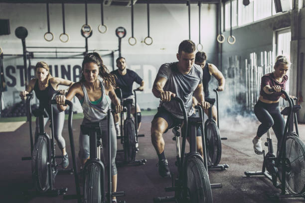 istock gym training on stationary bikes in a gym! 1337763022