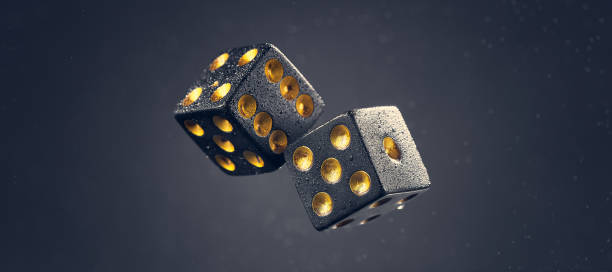 istock Two black dice are falling on a dark gray background. Photo with bokeh. 1337765492