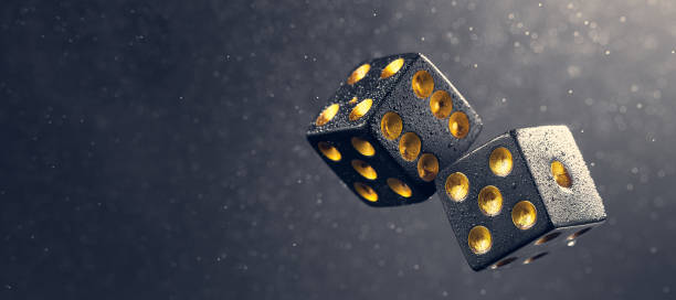 istock Two black dice are falling on a dark gray background. Photo with bokeh. Photo with copy space. The light falls from the side. 1337765511