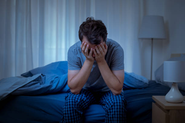 Man suffering depression and feeling negative emotions Depressed man at night feeling alone and useless insomnia stock pictures, royalty-free photos & images