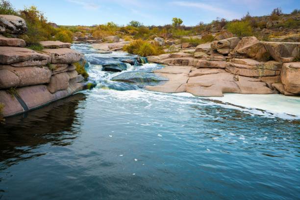 istock A small shining stream flows among smooth wet and dark stones 1337767045