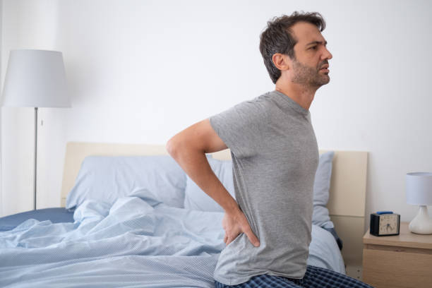 istock Man lying in bed and suffering from back pain 1337767776