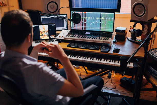 istock Dedicated musician, leading e-class via video call, from his music studio 1337770788