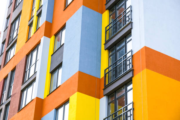 Modern building angle and windows. Multistory new multicolored apartment building. Stylish living block of flats. Bright juicy colors in the construction of buildings