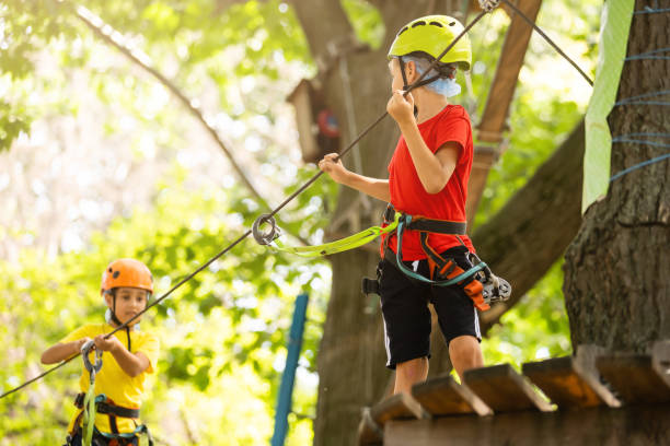 istock Boy climber walks on the rope bridge, 1337774522