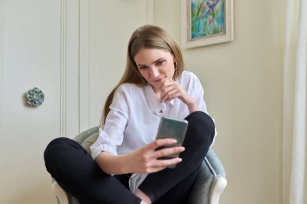 istock Emotional young beautiful woman looking at smartphone screen 1337776326