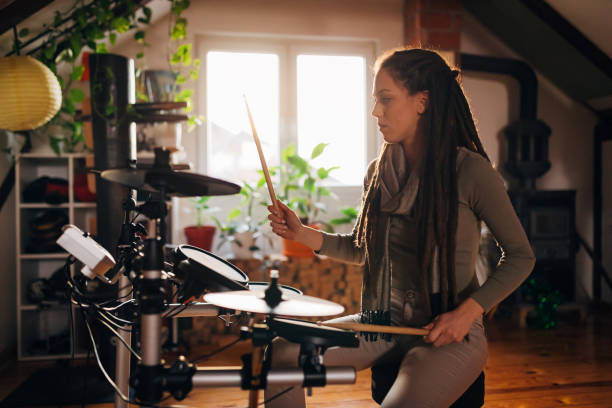 istock Alternative female drummer, enjoying the alone time while playing drums in her home music studio 1337777018