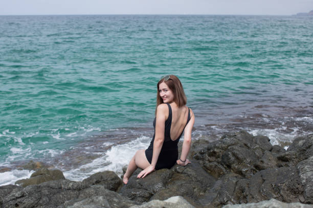 istock Pretty girl on wild rocky seashore 1337778055