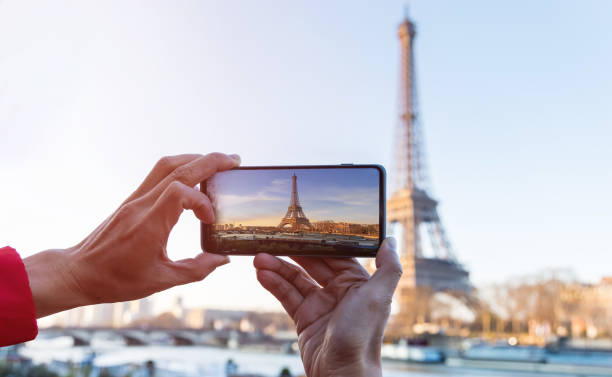 istock Selective focus of man hand with he is using smartphone take photo at View on Eiffel Tower, Paris, France 1337778103