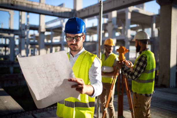 istock Business building teamwork people concept. Group of engineer with blueprint on construction site 1337778415