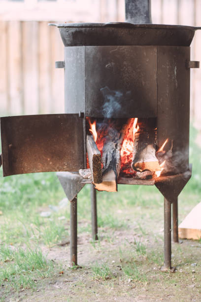 istock Open firebox of yard cauldron, with firewood burning in it 1337783592
