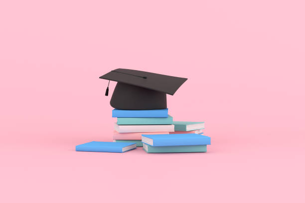 istock 3d rendering of graduation cap and books on pink background. 1337784489