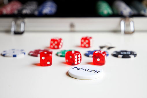 dice and poker material with briefcase in the background