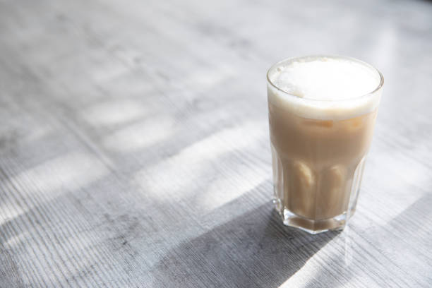 istock Glass of iced coffee in dappled light 1337784715