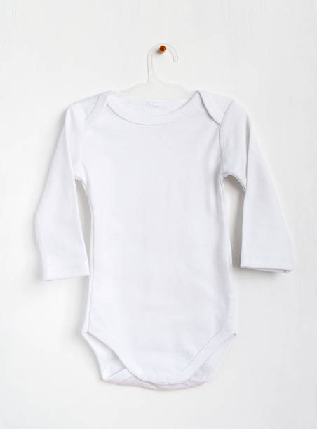 istock White baby clothes on a hanger. Mockup for design. 1337785065