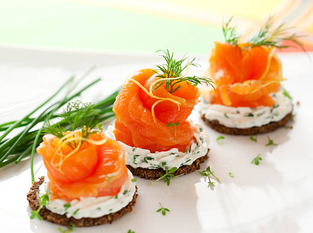 Canapes with smoked salmon Canapes with smoked salmon and cream cheese for holiday canape stock pictures, royalty-free photos & images