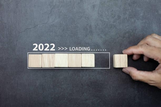 istock Loading new year 2022 concept, hand man putting cube wooden on process bar. 1337786639